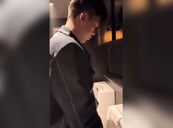 A male is pissing in the toilet 8