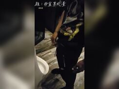 A male is pissing in the toilet 13