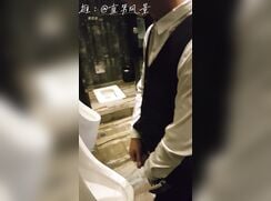 A male is pissing in the toilet 14